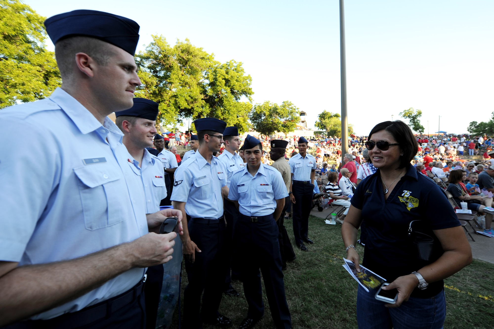 U.S. Air Force Chief Master Sgt. JoAnne Bass, 17th Training Wing Command Chief, speaks with volunteers at the 29th Annual San Angelo Symphony July 3rd Pops Concert at the Bill Aylor Sr. Memorial RiverStage in San Angelo, Texas, July 3, 2016. The volunteers assisted the concert by displaying state flags, presenting an American flag and providing a flyover. (U.S. Air Force photo by Senior Airman Joshua Edwards/Released)