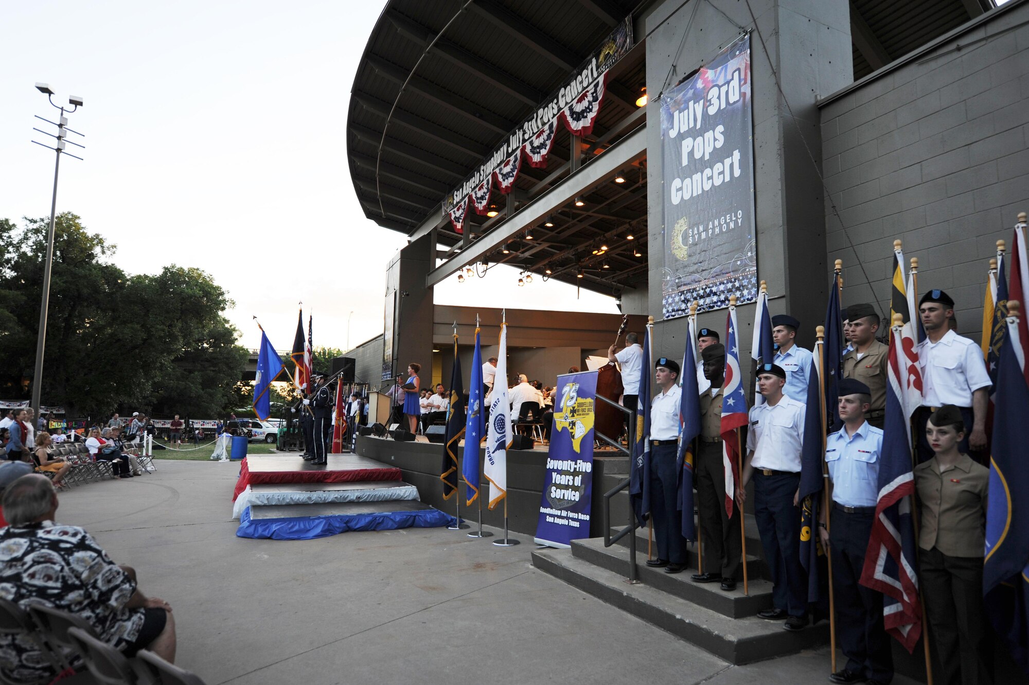 The Goodfellow Air Force Base Honor Guard presents the colors while service members display state flags during the 29th Annual San Angelo Symphony July 3rd Pops Concert at the Bill Aylor Sr. Memorial RiverStage in San Angelo, Texas, July 3, 2016. While the service members presented the flags, the San Angelo Symphony played “A Salute to the Armed Forces.” (U.S. Air Force photo by Senior Airman Joshua Edwards/Released)