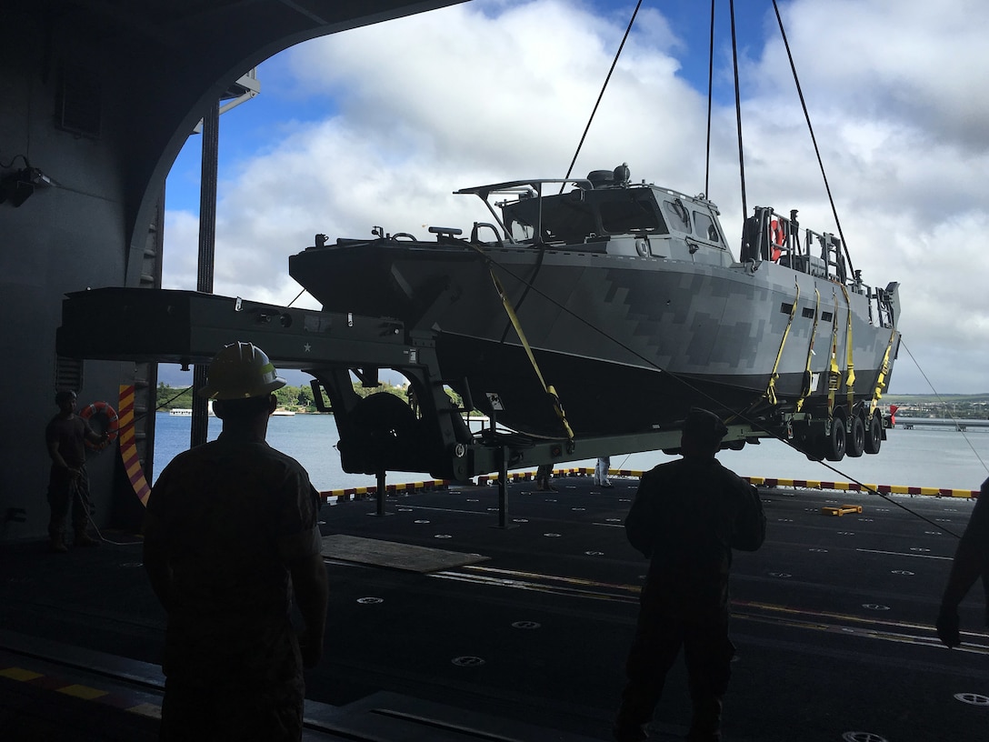 A Riverine Command Boat (RCB) from Coastal Riverine Squadron 3 (CRS-3) is unloaded off of amphibious assault ship USS America (LHA 6) for Rim of the Pacific 2016. Twenty-six nations, more than 40 ships and submarines, more than 200 aircraft, and 25,000 personnel are participating in RIMPAC from June 30 to Aug. 4, in and around the Hawaiian Islands and Southern California. The world's largest international maritime exercise, RIMPAC provides a unique training opportunity that helps participants foster and sustain the cooperative relationships that are critical to ensuring the safety of sea lanes and security on the world's oceans. RIMPAC 2016 is the 25th exercise in the series that began in 1971. 