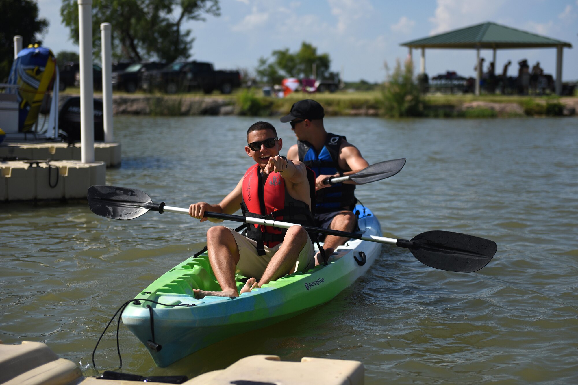 Goodfellow Air Force Base members row a kayak during the 4th of July Celebration at Goodfellow Air Force Base Recreation Camp in San Angelo, Texas, July 4, 2016. Volunteers from Goodfellow helped issue gear and kayaks to participants for their use. (U.S. Air Force photo by Airman 1st Class Caelynn Ferguson/Released)