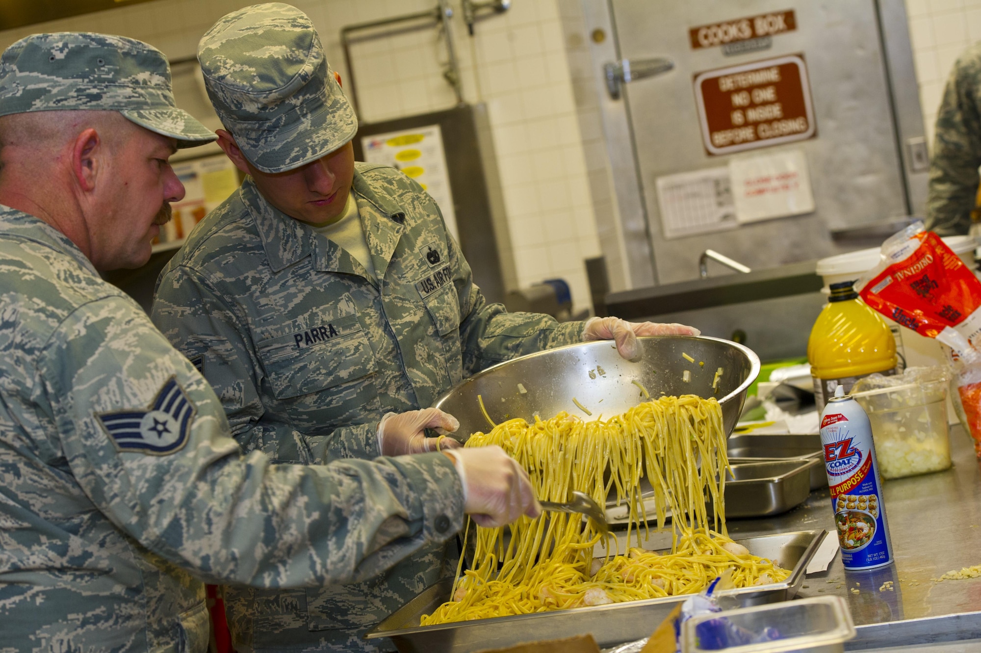 Staff Sgt. Alan Reese and Staff Sgt. Allan Parra, 926th Force Support Squadron service apprentices, pour pasta into a serving tray May 13, 2016, at the Crosswinds Dining Facility. Additional training for the 926th FSS Airmen was an initiative to help progress to their 5-level.