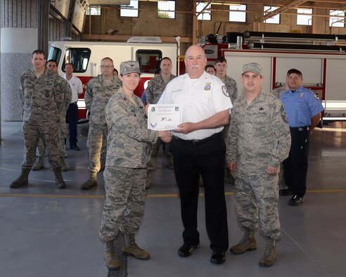 Craig Alexander, 47th Civil Engineer Squadron fire department health and safety assistant chief, accepts the “XLer of the Week” award from Col. Michelle Pryor, left, 47th Flying Training Wing vice commander, and Chief Master Sgt. George Richey, 47th FTW command chief, here, June 29, 2016. The XLer is a weekly award chosen by wing leadership and is presented to those who consistently make outstanding contributions to their unit and Laughlin. (U.S. Air Force photo/Airman 1st Class Brandon May)