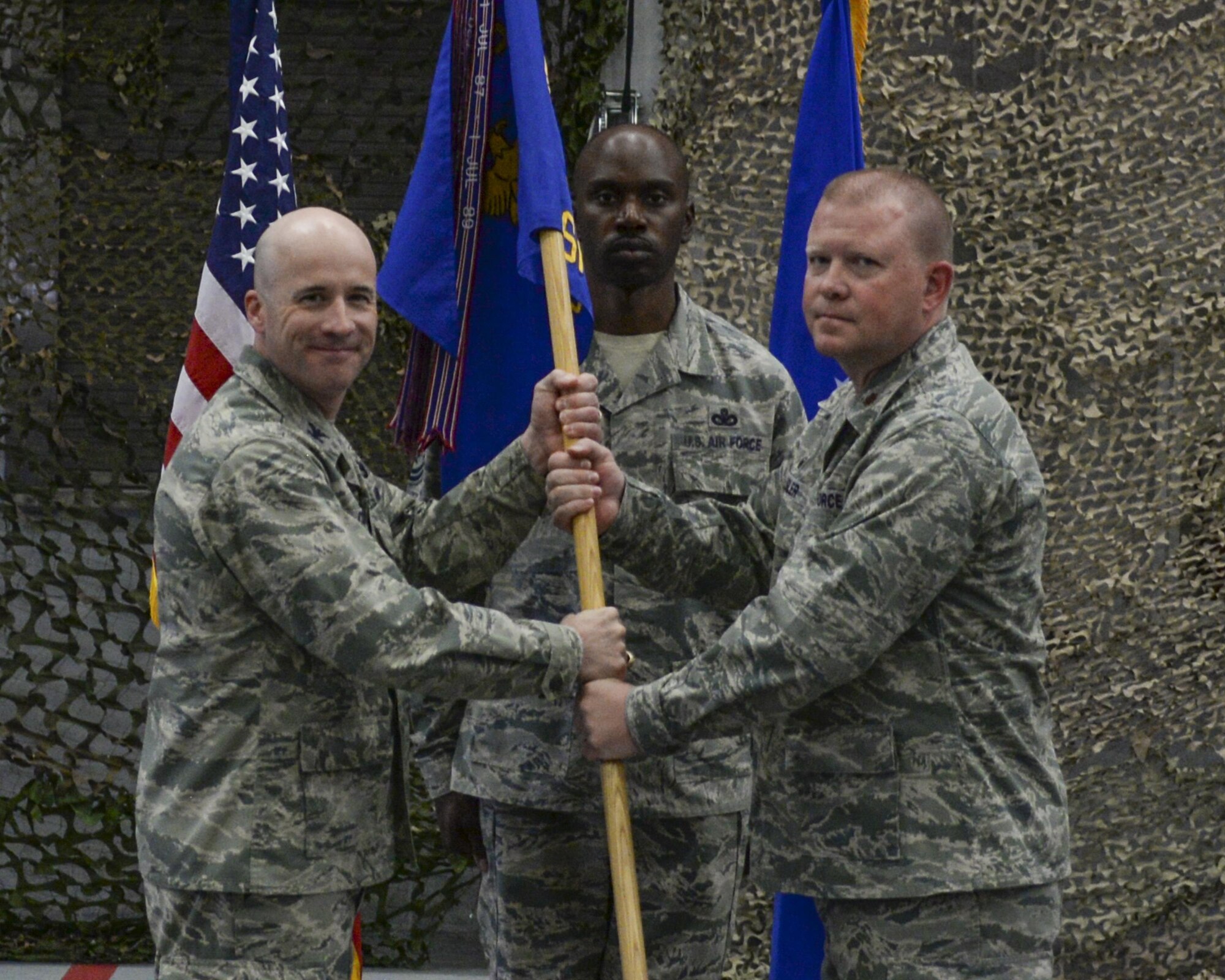 Col. Christopher Corley, 90th Security Forces Group Commander, passes the guidon to Maj. Richard Zeigler, 90th Security Forces Squadron commander, during the 90th SFS change-of-command ceremony July 6, 2016, on F.E. Warren Air Force Base, Wyo. The ceremony signified the transition of command from Lt. Col. Amy Rivera to Zeigler. (U.S. Air Force photo by Senior Airman Jason Wiese)