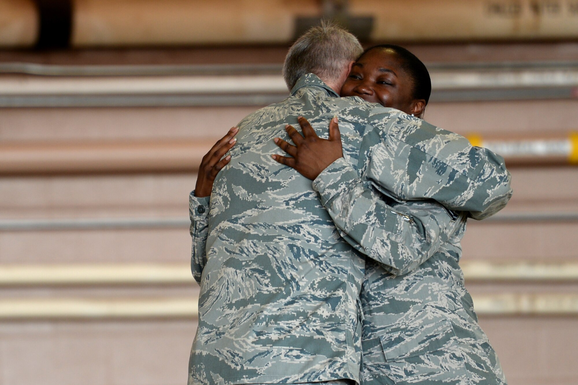 Lt. Gen. Darryl Roberson, Air Education and Training Command commander, hugs Master Sgt. Raneisha Russum, 82nd Force Support Squadron, manpower superintendent, after sharing her story of resiliency at Sheppard Air Force Base, Texas, June 29, 2016. The general was personally inspired by her story and recognized her during an all call with more than 3,000 Airmen. (U.S. Air Force photo by Senior Airman Kyle E. Gese)