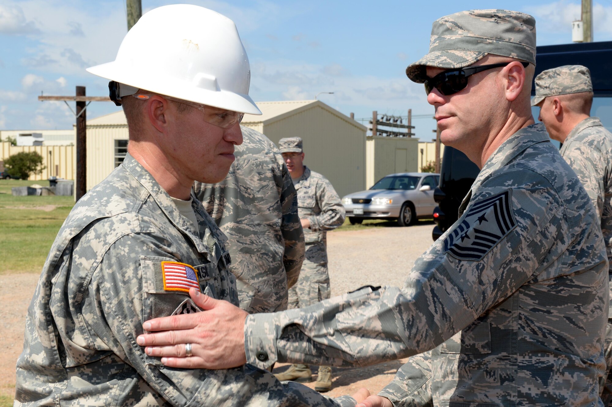 Command Chief Master Sgt. David Staton, Air Education and Training Command, shakes hands with U.S. Army Staff Sgt. Brad Eason, 366th Training Squadron electrical engineer instructor, after a brief course introduction at Sheppard Air Force Base, Texas, June 29, 2016. The chief visited Sheppard for three days for a familiarization tour of its training mission and capabilities. 