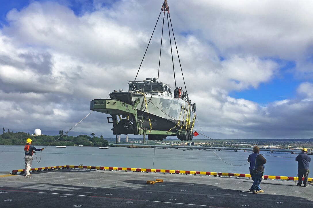 A crew offloads a Riverine Command Boat from the amphibious assault ship USS America for participation in Rim of the Pacific 2016 at Joint Base Pearl Harbor-Hickam, Hawaii, July 6, 2016. Navy photo by Lt. Travis Terran