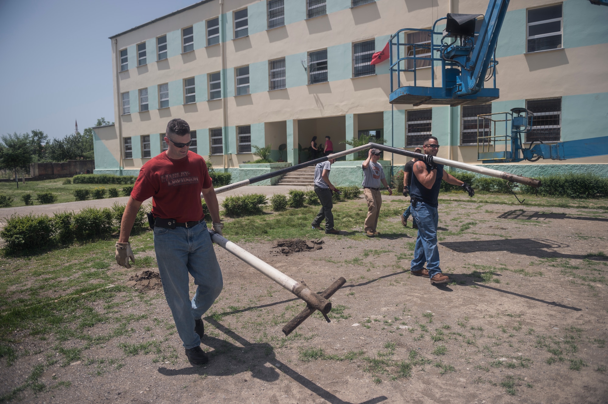 Soccer goal posts are removed from the local school in Mjede, Albania, to be reused for a new soccer field that Airmen from the 107th Civil Engineer Squadron, Niagara Falls Air Reserve Station, N.Y., are preparing during June 18-July 2, 2016. The Airmen did such work as cleaning up the grounds, replacing windows and painting as part of a Deployment For Training. (U.S. Air Force Photo by Staff Sgt. Ryan Campbell/Released)