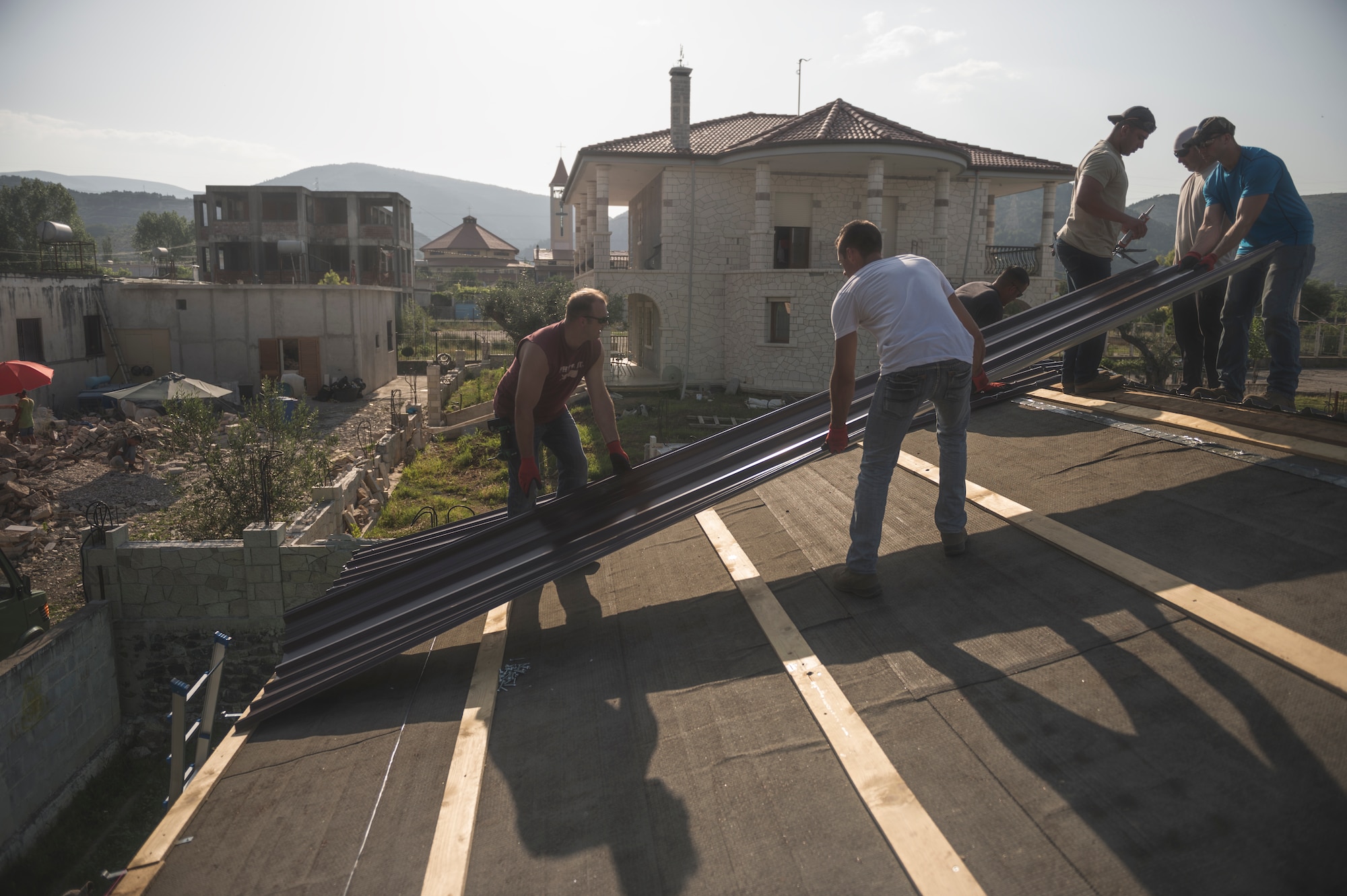 Airmen from the 107th Civil Engineer Squadron, Niagara Falls Air Reserve Station, N.Y., install a new roof on the clinic in Vau Dejes, Albania, June 18-July 2, 2016. The Airmen did such renovations as replacing walls, windows, doors and installing a 5,000 liter water tank as part of a Deployment For Training. (U.S. Air Force Photo by Staff Sgt. Ryan Campbell/released)