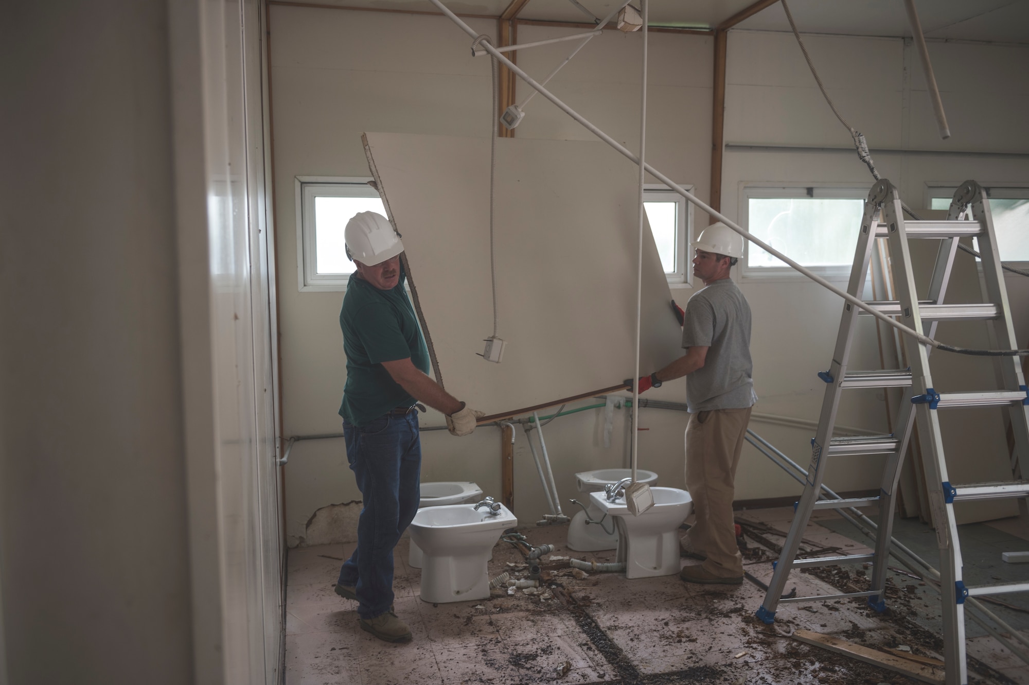 Airmen from the 107th Civil Engineer Squadron, Niagara Falls Air Reserve Station, N.Y., remove walls roof from the clinic in Vau Dejes, Albania, in order to repair the structure and replace damaged walls during June 18-July 2, 2016. The Airmen did such renovations as replacing walls, windows, doors and installing a 5,000 liter water tank as part of a Deployment For Training. (U.S. Air Force Photo by Staff Sgt. Ryan Campbell/released)