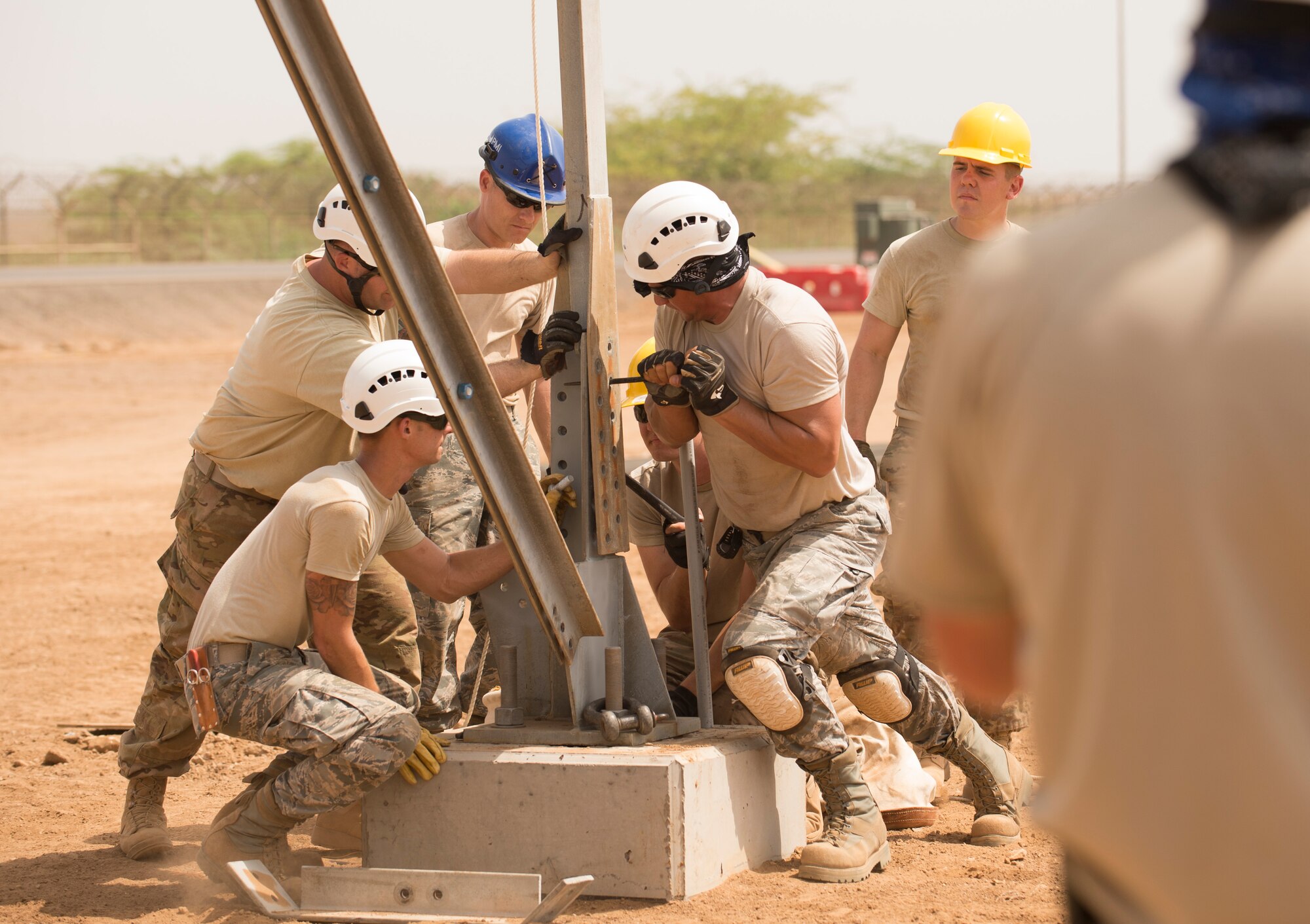 U.S. Air Force Airmen of the 205th Engineering Installation Squadron, Oklahoma City, line up pieces of the metal frame during construction of an AN/GPN-27 Airport Surveillance Radar System tower, May 26, 2016, at Camp Lemonnier, Djibouti. The new radar is a more permanent replacement for the short-term radar currently in operation. (U.S. Air Force photo by Staff Sgt. Tiffany DeNault)