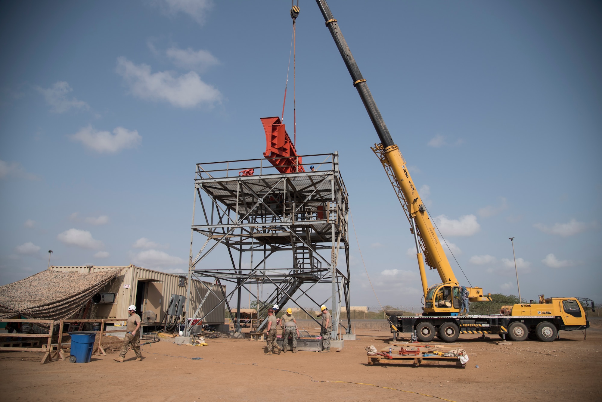 U.S. Air Force Airmen of the 205th Engineering Installation Squadron, Oklahoma City install a new AN/GPN-27 Airport Surveillance Radar System tower, June 4, 2016, at Camp Lemonnier, Djibouti. With coordination between the 205 EIS, U.S. Air Forces in Europe, U.S. Air Force Flight Standards Agency, U.S. Air Force Central Command and the U.S. Navy, the new radar will increase air traffic control capabilities and safety. (U.S. Air Force photo by Staff Sgt. Tiffany DeNault)