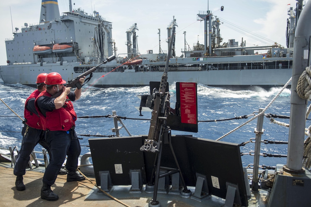 Navy Chief Petty Officer Joshua Tillman fires a shot line aboard the guided-missile destroyer USS Cole during a replenishment with the Military Sealift Command fleet replenishment oiler USNS Kanawha in the Atlantic Ocean, July 5, 2016. Tillman is a fire controlman. Navy photo by Petty Officer 2nd Class Jonathan B. Trejo
