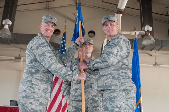 Col. Carl Misner, 51st Mission Support Group commander, hands the unit guidon to Col. Andrew Hansen, 51st Fighter Wing commander, during a change-of-command ceremony at Osan Air Base, Republic of Korea, July 6, 2016. Misner, who commanded the 51st MSG since 2014, was replaced by Col. Kerry Proulx. (U.S. Air Force photo by Staff Sgt. Jonathan Steffen/Released)
