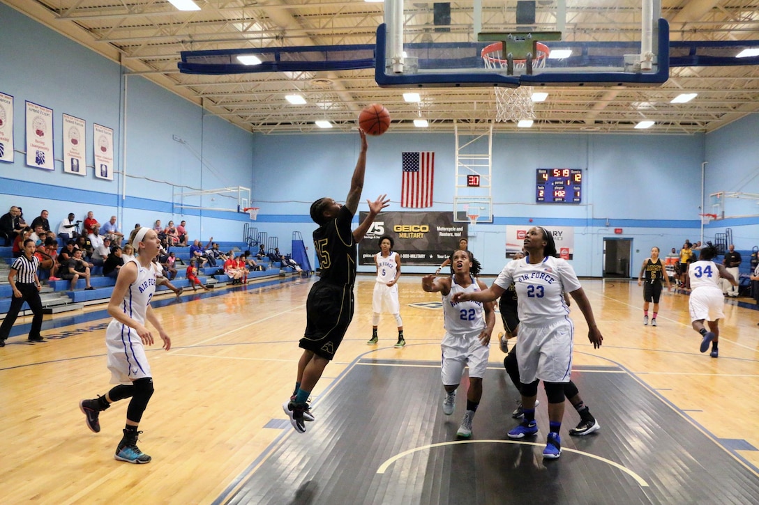 Army Spc. Danielle Deberry of (#15) of Fort Bragg, N.C. drives to the lane during game twelve of the 2016 Armed Forces Women's Basketball Championship at Joint Base San Antonio-Lackland AFB, Texas on 4 July.  Army won the game 78-66 over Air Force.