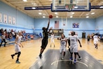 Army Spc. Danielle Deberry of (#15) of Fort Bragg, N.C. drives to the lane during game twelve of the 2016 Armed Forces Women's Basketball Championship at Joint Base San Antonio-Lackland AFB, Texas on 4 July.  Army won the game 78-66 over Air Force.