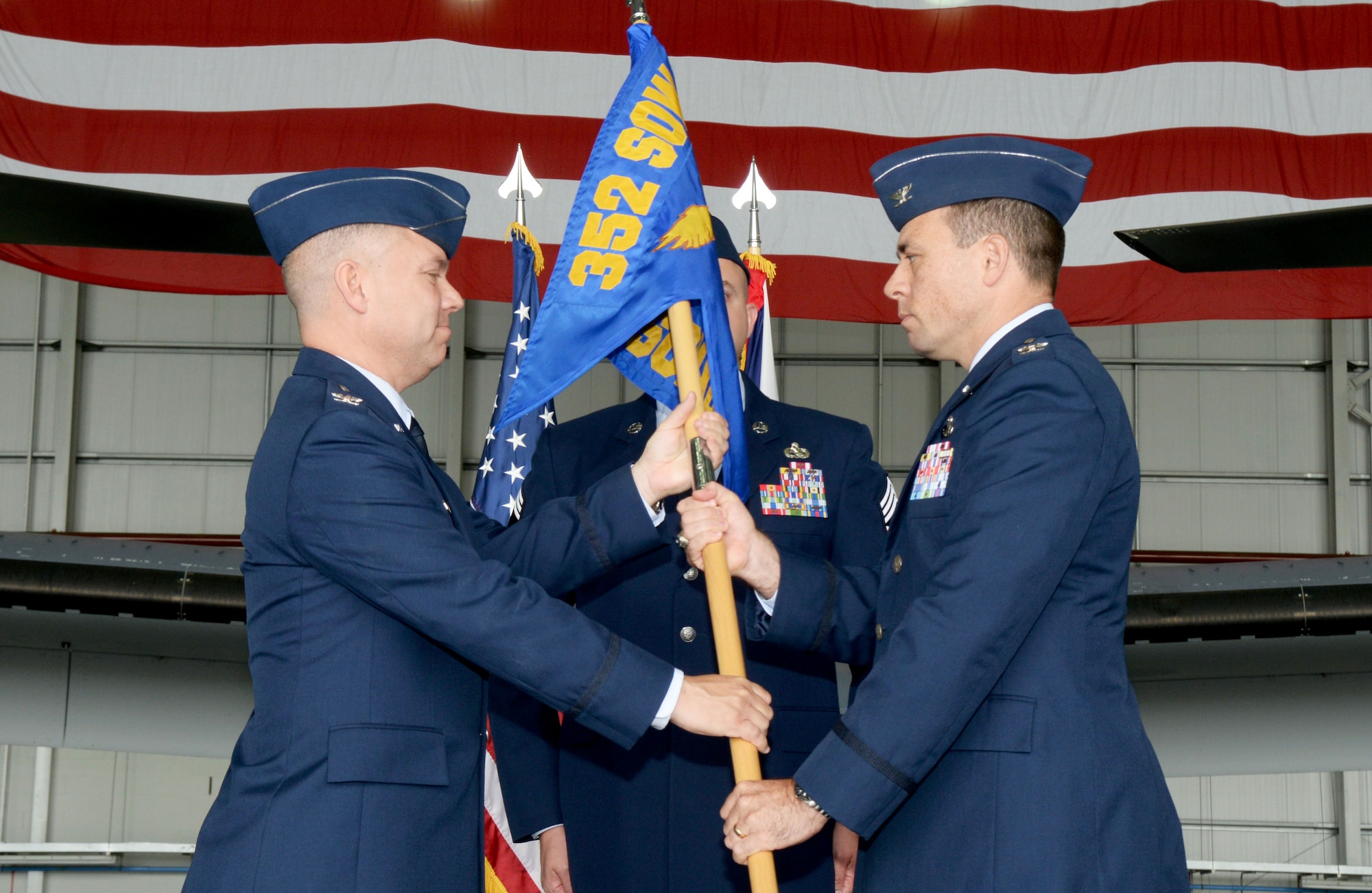 U.S. Air Force Col. William G. Holt, left, 352nd Special Operations Wing commander, passes the unit guideon to U.S. Air Force Col. Mark D. O’Reilly, right, 352nd Special Operations Maintenance Group incoming commander, July 7, 2016, during a change of command ceremony on RAF Mildenhall, England. The ceremony is a time-honored tradition in which one officer relinquishes command and passes it to another. (U.S. Air Force photo by Airman 1st Class Tenley Long/Released)