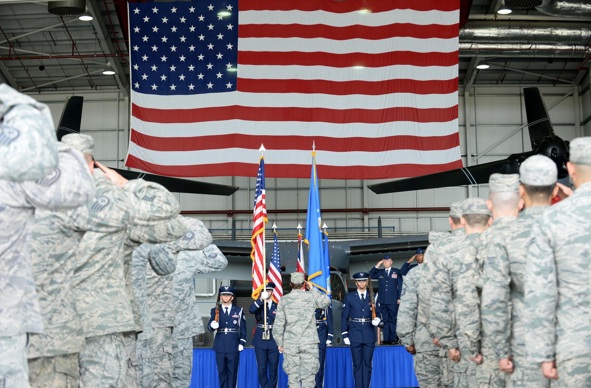 U.S. Air Force Airmen from the 352nd Special Operations Maintenance Group salute the American Flag July 7, 2016, during a change of command ceremony on RAF Mildenhall, England. During the ceremony U.S. Air Force Col. Eric V. Faison relinquished command of the 352nd SOMXG to Col. Mark D. O’Reilly. (U.S. Air Force photo by Airman 1st Class Tenley Long/Released)