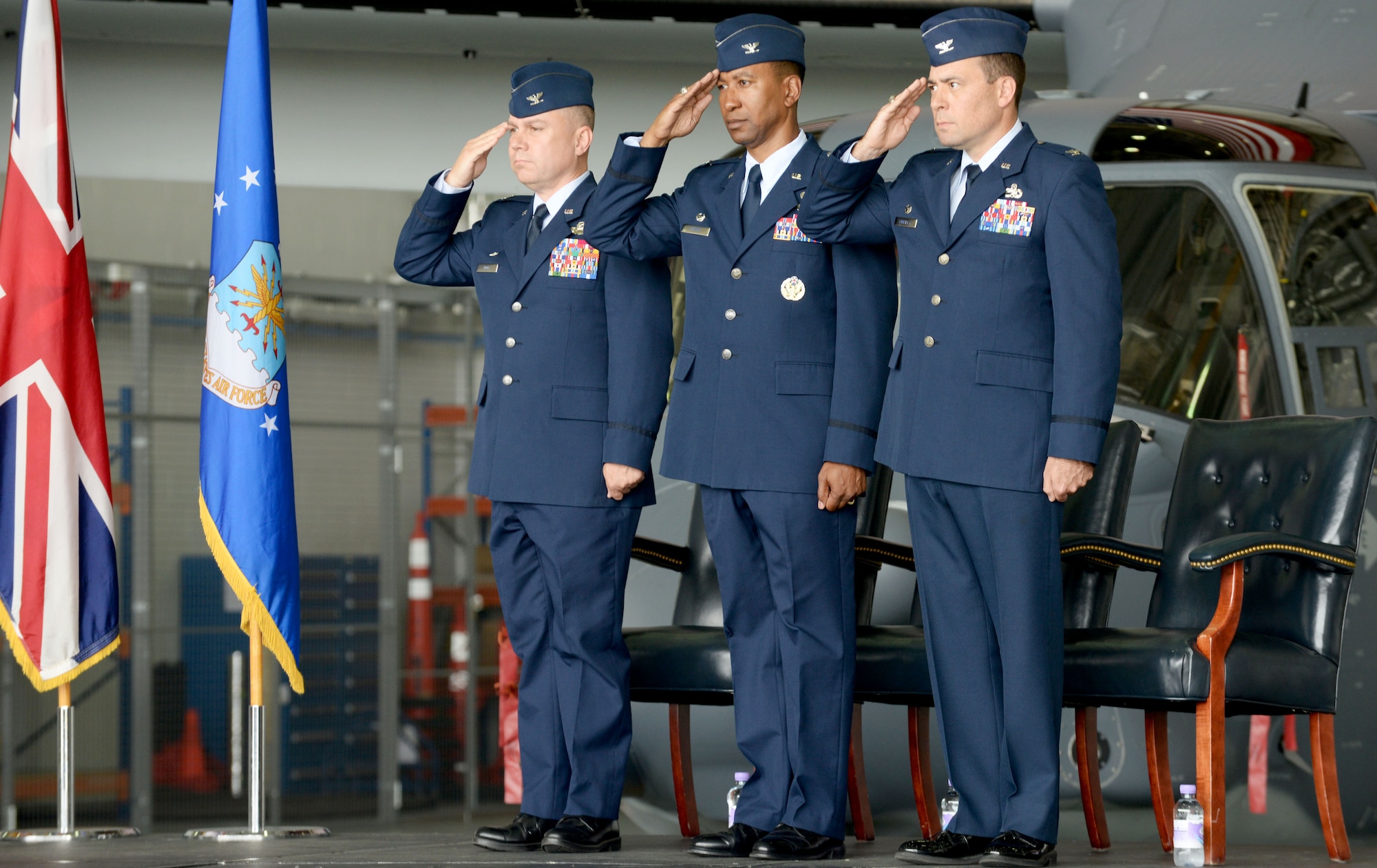 From left to right, U.S. Air Force Col. William G. Holt, 352nd Special Operations Wing commander, U.S. Air Force Col. Eric V. Faision, outgoing 352nd Special Operations Maintenance Group commander, and U.S. Air Force Col. Mark D. O’Reilly, incoming 352nd SOMXG commander, salute the American Flag during a change of command ceremony July 7, 2016, on RAF Mildenhall, England. The ceremony began with a presentation of the colors along with the singing of the U.S. National Anthem. (U.S. Air Force photo by Airmen 1st Class Tenley Long/Released)