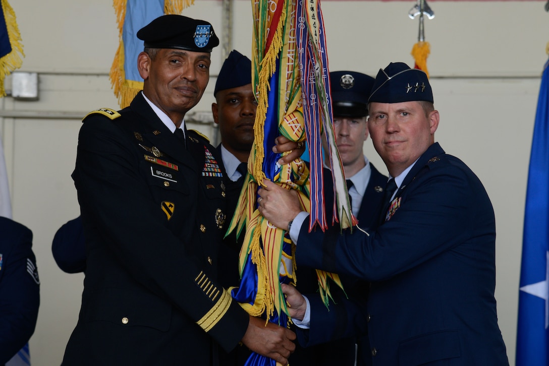 Lt. Gen. Thomas W. Bergeson accepts the Seventh Air Force guidon from Gen. Vincent K. Brooks, U.S. Forces Korea commander, during a change of command ceremony at Osan Air Base July 8, 2016. Bergeson became the 34th commander of Seventh Air Force, taking over for Lt. Gen. Terrence J. O'Shaughnessy who moves on to take over as Pacific Air Forces commander. (U.S. Air Force photo by Senior Airman Dillian Bamman/Released)