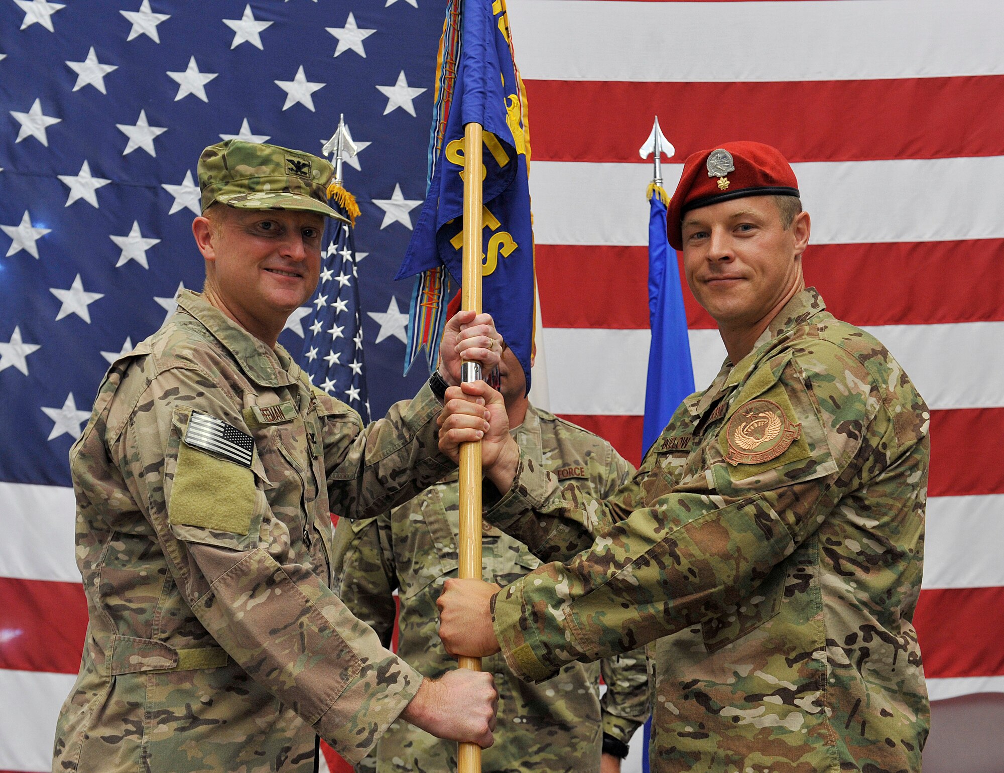 U.S. Air Force Col. William Freeman, 353rd Special Operations Group commander, passes the guidon to U.S. Air Force Maj. Joel Buelow, 320th Special Tactics Squadron commander, during the 320th STS change of command on Kadena Air Base, Japan, June 23, 2016.   (U.S. Air Force photo by Naoto Anazawa)