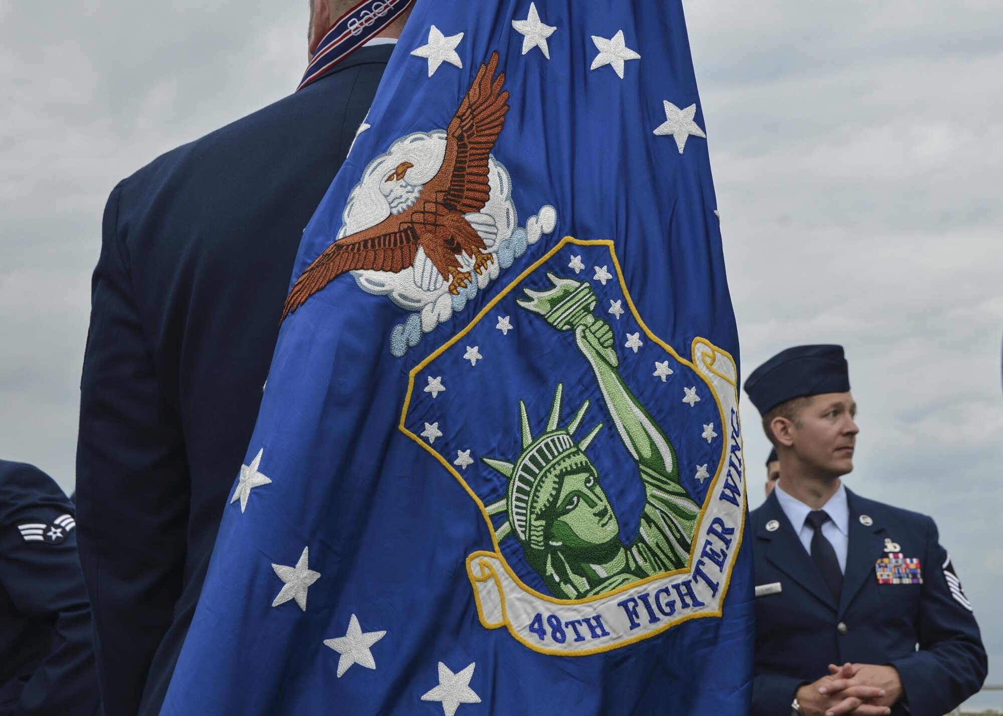 An Airman carries the 48th Fighter Wing flag during the Royal Norfolk Show in Norfolk, England, June 30. Royal Air Force Lakenheath participated in the annual Royal Norfolk Show, showcasing the military branches in the area. (U.S. Air Force photo/Senior Airman Nigel Sandridge)