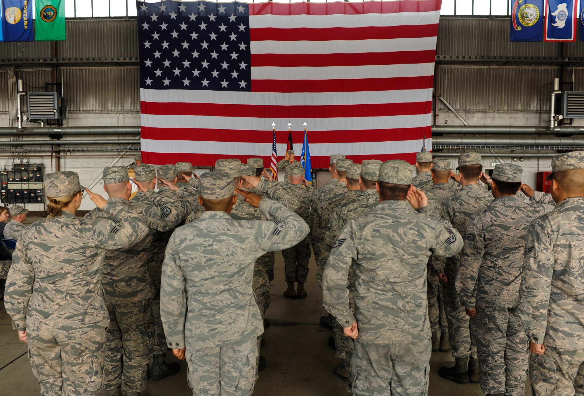 Airmen assigned to the 52nd Aircraft Maintenance Squadron salute U.S. Air Force Maj. John Szcepanski, 52nd AMXS commander, during an assumption of command ceremony at Hangar One on Spangdahlem Air Base, Germany, July 8, 2016. Ceremonies of this nature usually include the incoming commanders rendering their first salute to their new squadron. (U.S. Air Force Photo by Staff Sgt. Joe W. McFadden/Released)