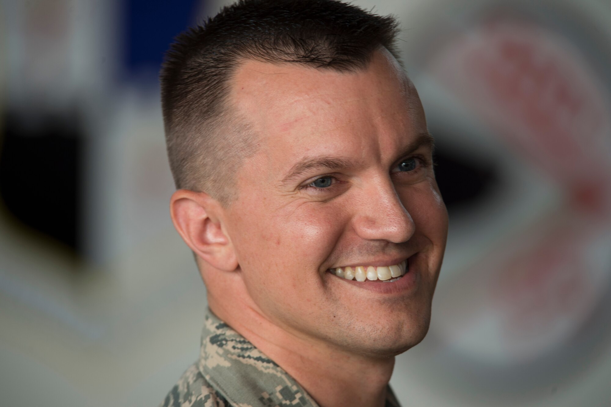 U.S. Air Force Maj. John Szcepanski, incoming 52nd Aircraft Maintenance Squadron commander, smiles as he shakes hands with fellow Airmen after an assumption of command ceremony at Hangar One on Spangdahlem Air Base, Germany, July 8, 2016. Szcepanski assumed command of the squadron and previously served as a maintenance operations officer for the 756th AMXS at Luke Air Force, Base, Ariz. (U.S. Air Force Photo by Staff Sgt. Joe W. McFadden/Released)