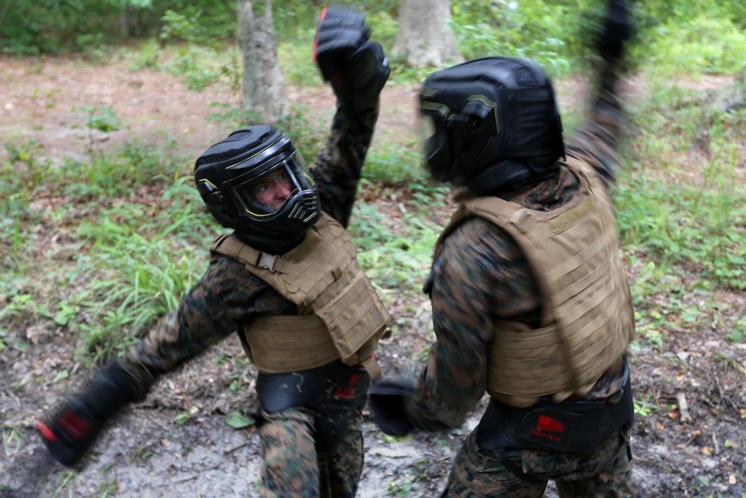 Marines with Marine Wing Communication Squadron 28 participate in a sparring during the four-and-a-half mile endurance course of a Marine Corps Martial Arts Instructor Course at Marine Corps Air Station Cherry Point, N.C., July 1, 2016. The endurance course was the culminating event of three weeks of physical, mental, and character challenges Marines assigned to MWCS-28 completed to earn their instructor tabs. MCMAP is a combat system that trains Marines in the art of hand-to-hand and close quarters combat techniques while building morale and team-building functions. This MCMAP instructor course was conducted by the unit to certify Marines with the responsibility of instructing and training Marines in MCMAP. MWCS-28 is one of the squadrons assigned to Marine Air Control Group 28, 2nd Marine Aircraft Wing. (U.S. Marine Corps photo by Cpl. N.W. Huertas/Released)