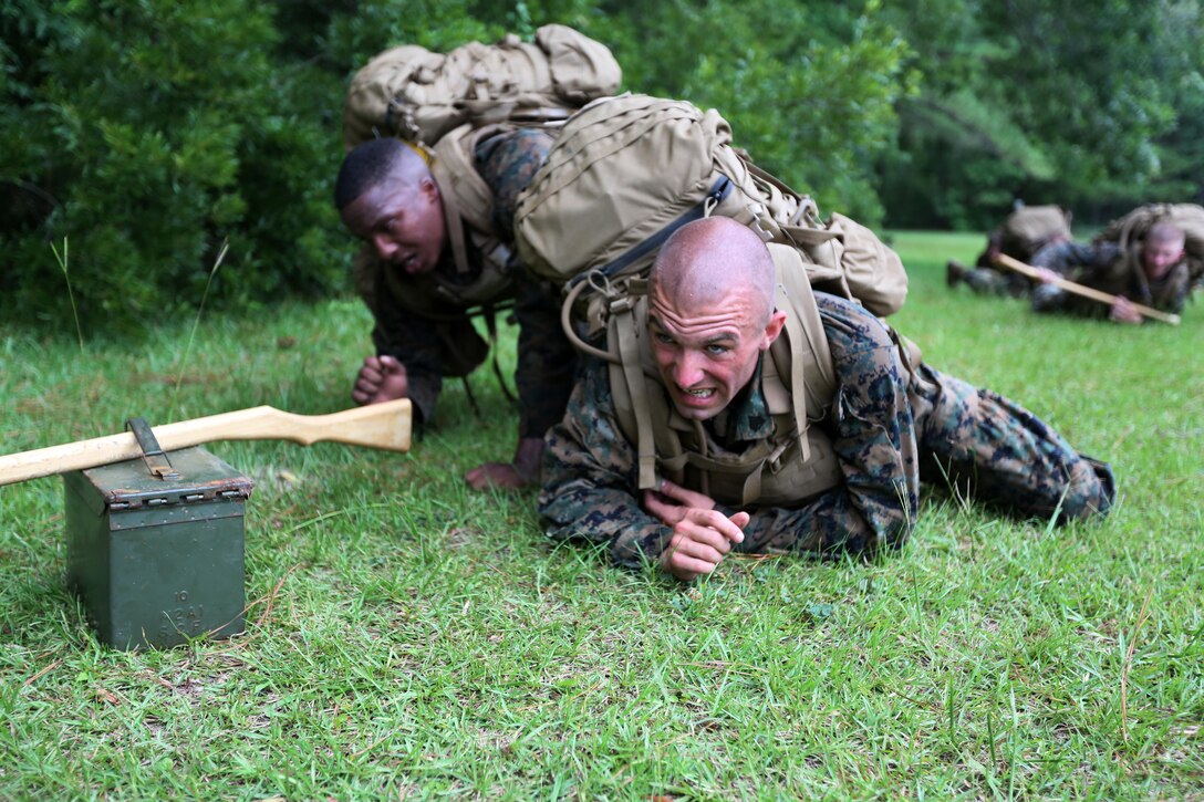 Marines with Marine Wing Communication Squadron 28 participate in a team event during the four-and-a-half mile endurance course of a Marine Corps Martial Arts Instructor Course at Marine Corps Air Station Cherry Point, N.C., July 1, 2016. The endurance course was the culminating event of three weeks of physical, mental, and character challenges Marines assigned to MWCS-28 completed to earn their instructor tabs. MCMAP is a combat system that trains Marines in the art of hand-to-hand and close quarters combat techniques while building morale and team-building functions. This MCMAP instructor course was conducted by the unit to certify Marines with the responsibility of instructing and training Marines in MCMAP. (U.S. Marine Corps photo by Cpl. N.W. Huertas/Released)