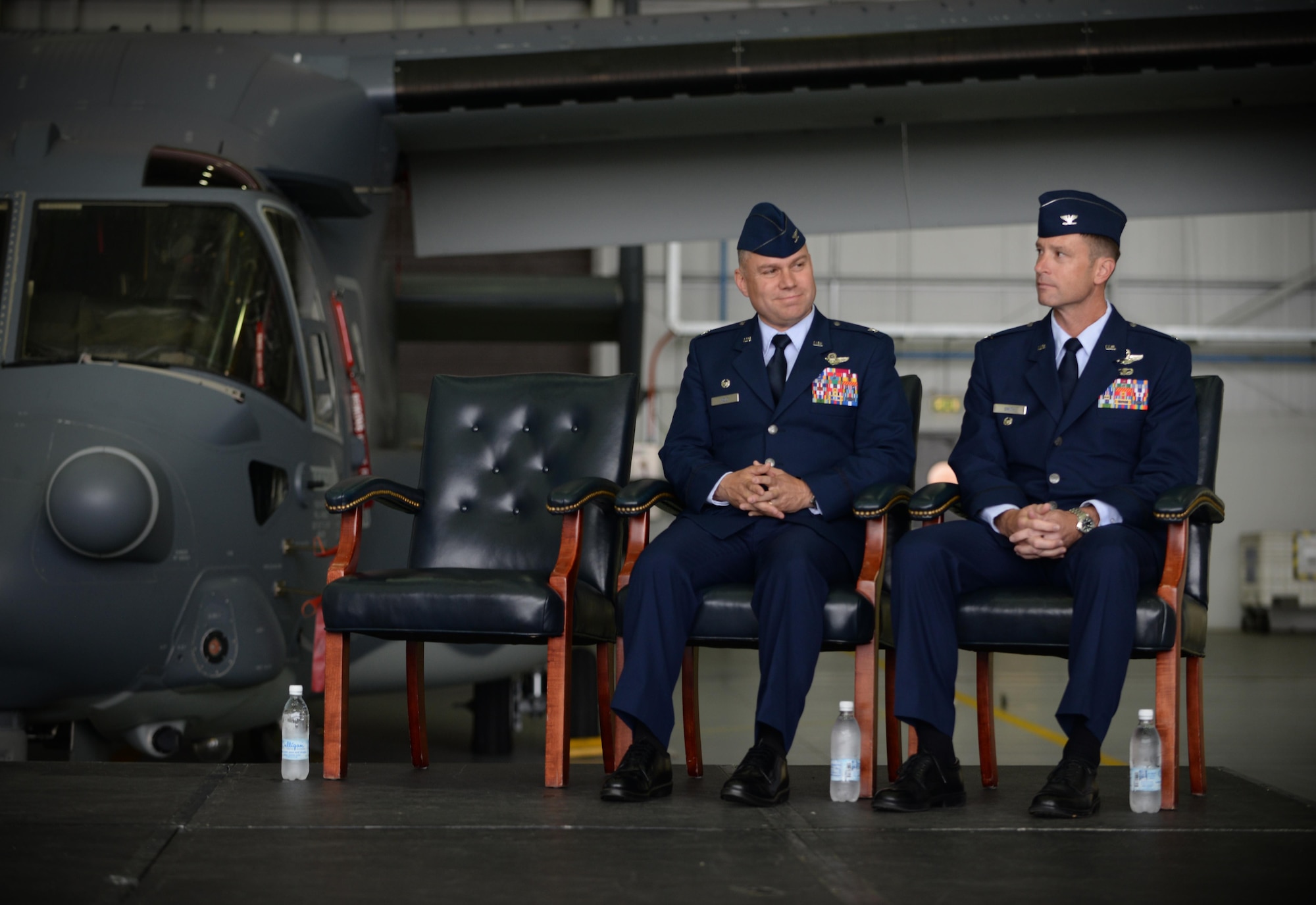 U.S. Air Force Col. William Holt, left, 352nd Special Operations Wing commander, and U.S. Air Force Col. Matthew Smith, 352nd SOW incoming commander, listen as Maj. Gen Eugene Haase, Air Force Special Operations Command vice commander, give a speech during the 352 SOW change of command ceremony July 8, 2016, on RAF Mildenhall, England. Smith took command of the 352nd SOW following U.S. Air Force Col. William Holt’s departure as part of routine military assignment rotations. (U.S. Air Force photo by Senior Airman Christine Halan/Released)