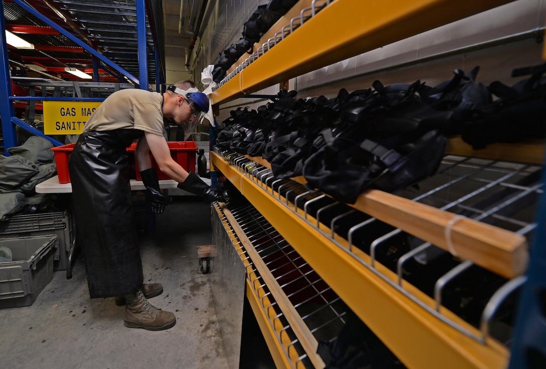 Airman 1st Class Maxwell Dean, a material management apprentice with the 1st Special Operations Logistics Readiness Squadron, places a gas mask on a drying rack at Hurlburt Field, Fla., July 7, 2016. Gas masks are left to dry overnight before being tested for leaks and blockage the next day. (U.S. Air Force photo by Senior Airman Andrea Posey)