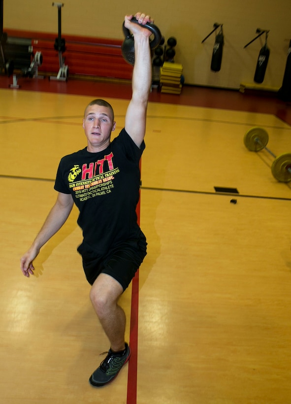 Cpl. Ethan Mawhinney, a Marine Air-Ground Task Force Planner with U.S. Marine Corps Forces Command Headquarters, executes a Turkish get-up with a kettlebell during his daily workout in preparation for the Tactical Athlete Challenge, July 7, 2016. Mawhinney and Sgt. Aja'Nel Williams, a supply noncommissioned officer with Security Forces Regiment, were the top two Marines competing in the Camp Allen HITT preliminaries, which afforded them the opportunity to compete at the national Tactical Athlete Competition, where they will compete against other regional qualifiers throughout the Marine Corps. (Official Marine Corps photo by Staff Sgt. Dorian Gardner/Released)