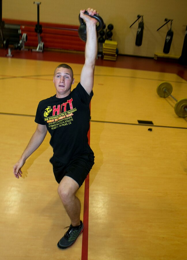 Cpl. Ethan Mawhinney, a Marine Air-Ground Task Force Planner with U.S. Marine Corps Forces Command Headquarters, executes a Turkish get-up with a kettlebell during his daily workout in preparation for the Tactical Athlete Challenge, July 7, 2016. Mawhinney and Sgt. Aja'Nel Williams, a supply noncommissioned officer with Security Forces Regiment, were the top two Marines competing in the Camp Allen HITT preliminaries, which afforded them the opportunity to compete at the national Tactical Athlete Competition, where they will compete against other regional qualifiers throughout the Marine Corps. (Official Marine Corps photo by Staff Sgt. Dorian Gardner/Released)