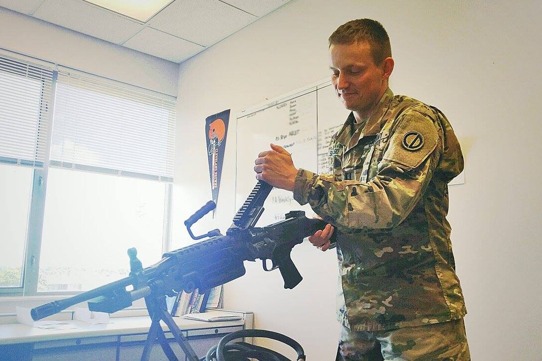Army Reserve capt. Jason Smigelski, G3/Training Officer, 85th Support Command, conducts a visual/physical inspection of the M249 to determine if there are any noticeable defects. The weapon is one of several weapon systems used in the command's EST-2000 (engagement skills trainer). The 85th Support Command houses a 10-lane system for use in zeroing to qualifying in a dedicated building at the command's installation. The EST 2000 provides a variety of weapon ranging from the M9 to the M136/AT4. The facility is available for federal, local and state agencies to train on and it sees use by a wide variety of organizations throughout the year. The EST 2000 creates a realistic marksmanship and combat scenario training for 12 of the most common small arms and crew-served weapons and individual anti-tank weapons in the US Army inventory.
 (Photo by Mr. Anthony L. Taylor)