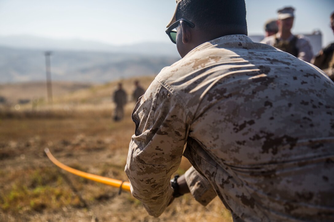 MARINE CORPS BASE CAMP PENDLETON, Calif. -- Corporal Larae Butler, a military policeman with Law Enforcement Platoon, Koa Moana 16-4, uses a holly stick to locate mock improvised explosive device wires on Camp Pendleton June 23, 2016. A holly stick is used to help confirm the spotting of an IED. Koa Moana seeks to enhance senior military leader engagements between allied and partner nations with a collective interest in military-to-military relations, as well as discuss key aspects of military operations, capability development, and interoperability. (U.S. Marine Corps photo by Sgt. Tony Simmons)
