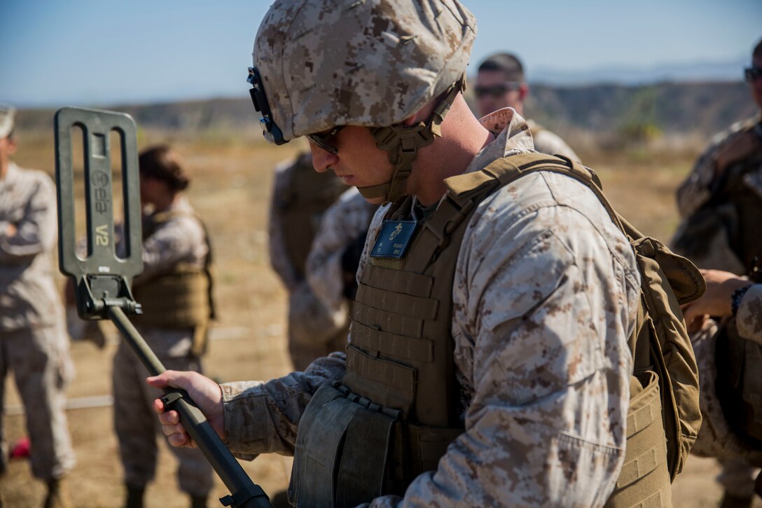 MARINE CORPS BASE CAMP PENDLETON, Calif. -- Corporal David Nygaard, an armorer with Headquarters Platoon, Koa Moana 16-4, calibrates a compact metal detector before locating mock improvised explosive devices on Camp Pendleton June 23, 2016. The CMD is capable of detecting metal or carbon devices during patrols. Koa Moana seeks to enhance senior military leader engagements between allied and partner nations with a collective interest in military-to-military relations, as well as discuss key aspects of military operations, capability development, and interoperability. (U.S. Marine Corps photo by Sgt. Tony Simmons)