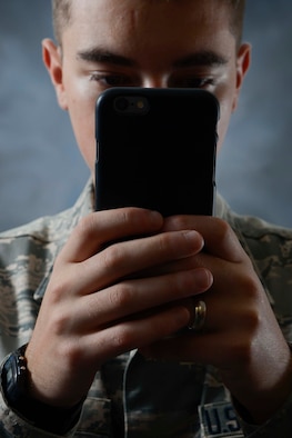 An Airman uses their phone to post to Facebook at MacDill Air Force Base, Fla., July 8, 2016. The Air Force views personal Web sites and weblogs positively, and respects the right of Airmen to use them as a medium of self-expression. However, as members of the Air Force, Airmen must abide by certain restrictions to ensure good order and discipline. 