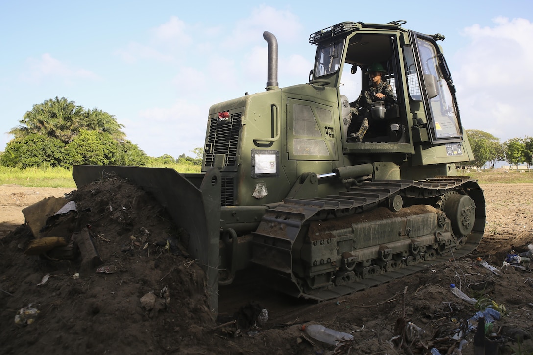 A Honduran engineer operates a D6K Bulldozer during a partner nation construction project between Honduran service members and U.S. Marines with Special Purpose Marine Air-Ground Task Force - Southern Command at Puerto Castilla, Honduras, June 24, 2016. The Marines worked side by side with their Honduran counterparts on different construction and restoration projects, and shared knowledge and experience on techniques including maintenance and operation of heavy equipment. (U.S. Marine Corps Photo by Cpl. Ian Ferro/Released)