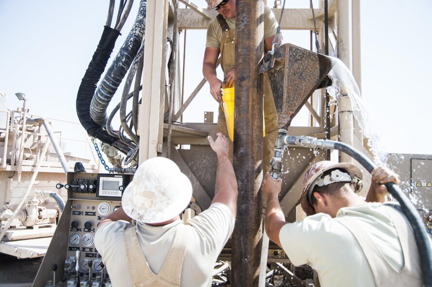 Airmen assigned to the 557th Expeditionary Red Horse Squadron's well drilling team, pour a sand and water mix down the well site at Al Taqaddum Air Base, Iraq, June 2, 2016. The 557th ERHS well drilling team are obtaining an organic water source for Al Taqaddum. Red Horse is helping to improve Iraq's infrastructure in support of the Government of Iraq.
(U.S. Air Force photo/Staff Sgt. Larry E. Reid Jr., Released)