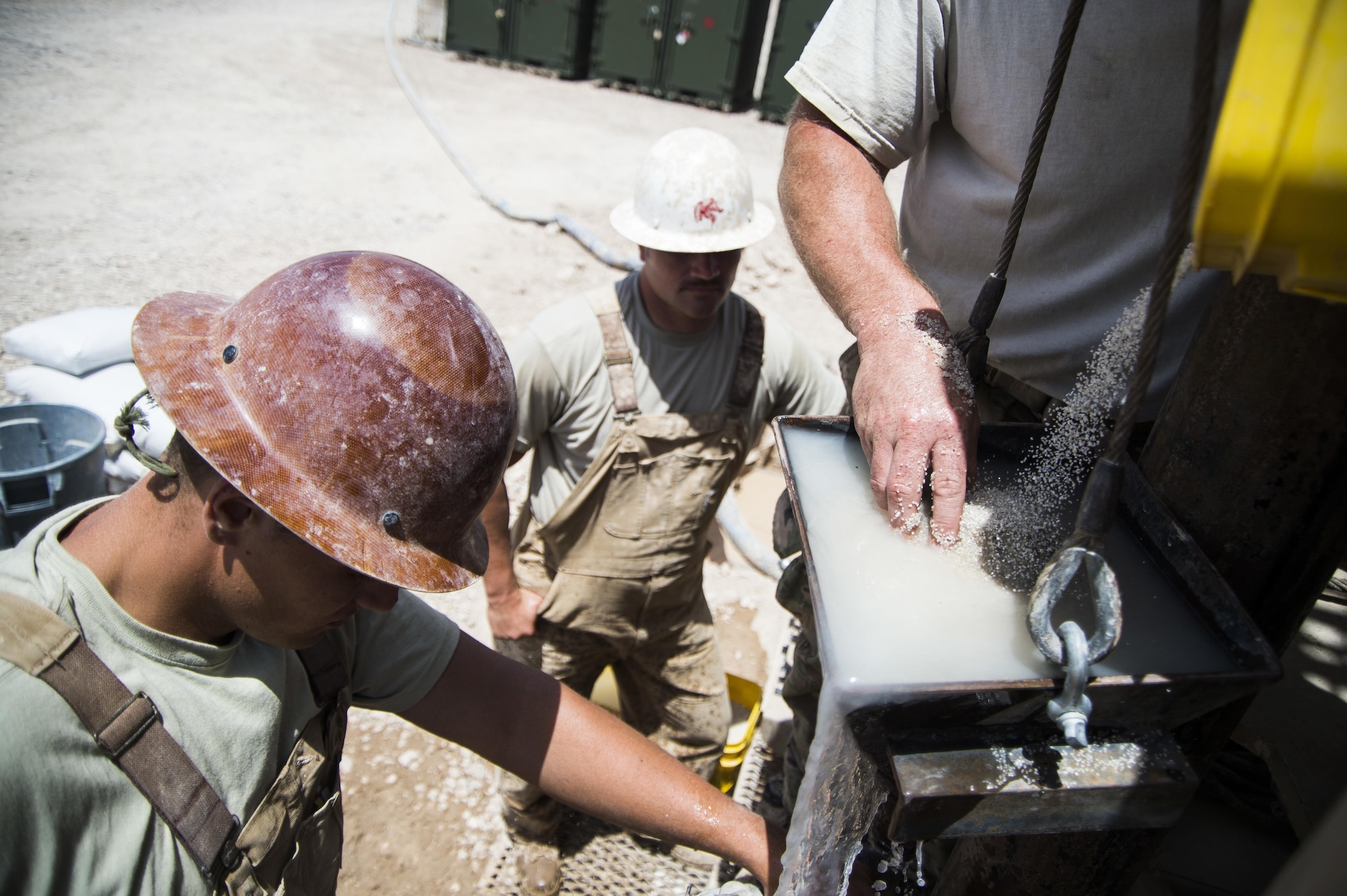 Airmen assigned to the 557th Expeditionary Red Horse Squadron, mix sand with water to pour into the well site at Al Taqaddum Air Base, Iraq, June 2, 2016. The 557th ERHS well drilling team are obtaining an organic water source for Al Taqaddum. Red Horse is helping to improve Iraq's infrastructure in support of the Government of Iraq.
(U.S. Air Force photo/Staff Sgt. Larry E. Reid Jr., Released)