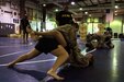 1st Lt. Rebecca Tracy (bottom), holds Spc. Leeza Pike, both Soldiers from the 10th Combat Support Hospital, in her guard during the final day of U.S. Army Combatives Level I training July 1 at Camp Arifjan, Kuwait. The class is a 40-hour course in the basics of hand-to-hand combat.