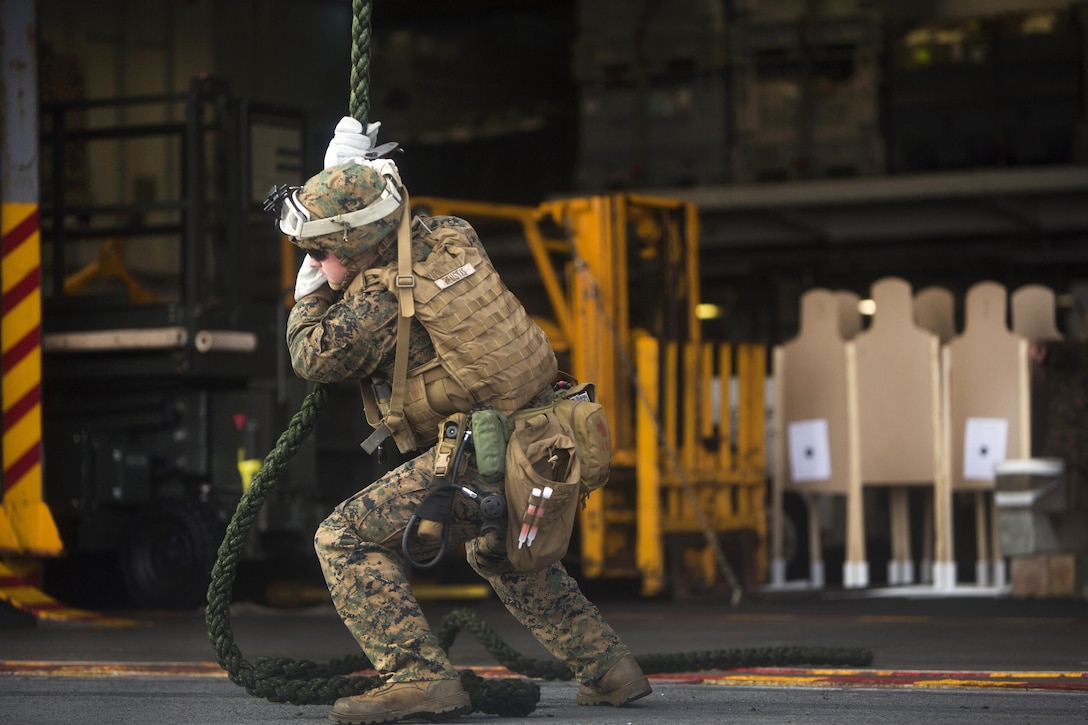 A Marine completes fast-rope training from the back of an MV-22 Osprey aircraft aboard the amphibious assault ship USS Wasp in the Atlantic Ocean, July 5, 2016. Marine Corps photo by Lance Cpl. Koby I. Saunders