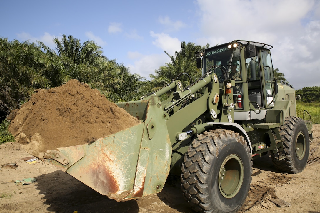 Cpl. Ivan A.  Barbosa, a heavy equipment operator with Special Purpose Marine Air-Ground Task Force - Southern Command, operates a 624KR TRAM during a partner-nation construction project between Honduran service members and U.S. Marines at Puerto Castilla, Honduras, June 24, 2016. The Marines worked side by side with Honduran engineers on different construction and restoration projects, and shared knowledge and experience on techniques including maintenance and operation of heavy equipment. (U.S. Marine Corps photo by Cpl. Ian Ferro/Released)
