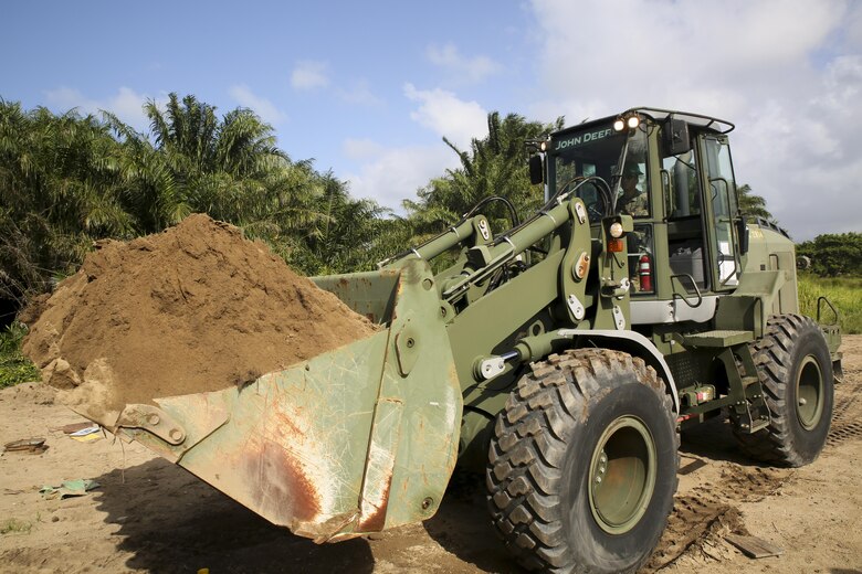 Cpl. Ivan A.  Barbosa, a heavy equipment operator with Special Purpose Marine Air-Ground Task Force - Southern Command, operates a 624KR TRAM during a partner-nation construction project between Honduran service members and U.S. Marines at Puerto Castilla, Honduras, June 24, 2016. The Marines worked side by side with Honduran engineers on different construction and restoration projects, and shared knowledge and experience on techniques including maintenance and operation of heavy equipment. (U.S. Marine Corps photo by Cpl. Ian Ferro/Released)