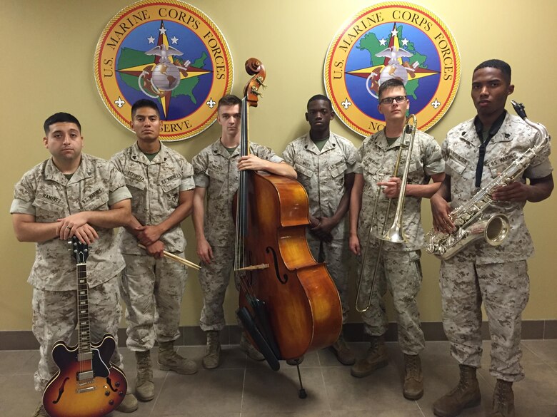 Marine Corps Band New Orleans Jazz Ensemble Marines pose for a picture after receiving Marine Corps Band Small Ensemble of the Year for fiscal year 2015 in New Orleans, July 7, 2016.  The members of the Jazz Ensemble won by selecting a unique piece called Martha’s Prize by Cedar Walton performed by singer and drummer Jamison Ross, a local New Orleans musician.  (U.S. Marine Corps photo by Lance Cpl. Devan A. Barnett)