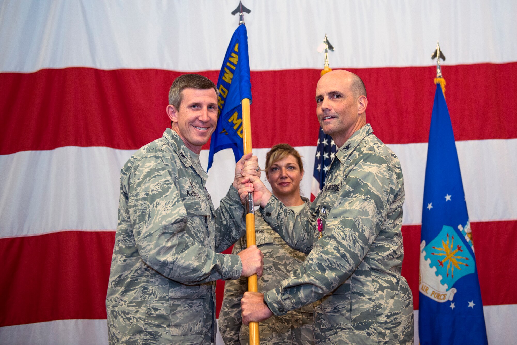 U.S. Air Force Col. Peter Breed, right, relinquishes command of the 23d Medical Group during a change of command ceremony, July 8, 2016, at Moody Air Force Base, Ga. Under his leadership, the 23d MDG garnered the 2014 Air Combat Command Patient Safety Team Award and 10 Airmen were awarded ACC individual awards. (U.S. Air Force photo by Airman 1st Class Greg Nash/Released)