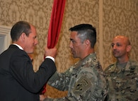 Alan W. Feistner (left), deputy district engineer for project management and chief of Planning, Programs and Project Management Division, receives the Corps colors from Lt. Col. Damon A. Delarosa (middle), Walla Walla District’s new commander. Delarosa assumed command of the U.S. Army Corps of Engineers, Walla Walla District, during a July 8, 2016, ceremony at the Marcus Whitman Hotel and Conference Center in downtown Walla Walla. Brig. Gen. Scott A. Spellmon (right), commander of the Corps’ Northwestern Division, presided over the ceremony. (U.S. Corps of Engineers photo)