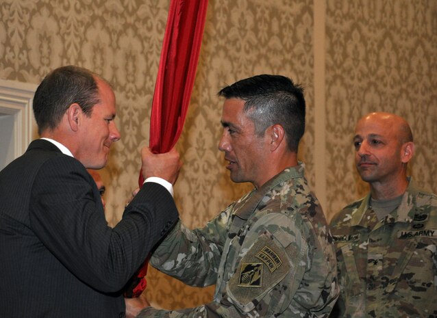 Alan W. Feistner (left), deputy district engineer for project management and chief of Planning, Programs and Project Management Division, receives the Corps colors from Lt. Col. Damon A. Delarosa (middle), Walla Walla District’s new commander. Delarosa assumed command of the U.S. Army Corps of Engineers, Walla Walla District, during a July 8, 2016, ceremony at the Marcus Whitman Hotel and Conference Center in downtown Walla Walla. Brig. Gen. Scott A. Spellmon (right), commander of the Corps’ Northwestern Division, presided over the ceremony. (U.S. Corps of Engineers photo)