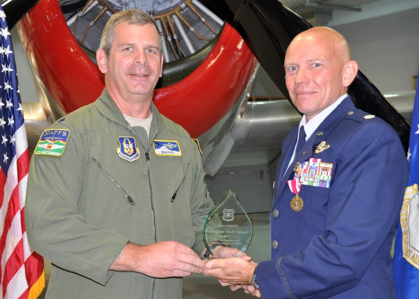 PETERSON AIR FORCE BASE, Colo. -- Air Force Reserve Lt. Col. James “Mark” Steward, right, receives the 2016 U.S. Forest Service “Spirit of MAFFS” award from Lt. Col. Brad Ross during Steward’s retirement ceremony June 4, 2016  here. The award recognizes contributions and achievements of individuals to the Modular Airborne Fire Fighting System mission. Steward has been part of the MAFFS mission with the 302nd Airlift Wing for 21 years. Ross is the 302nd Operations Support Squadron operations officer. (U.S. Air Force photo/2nd Lt. Stephen Collier)