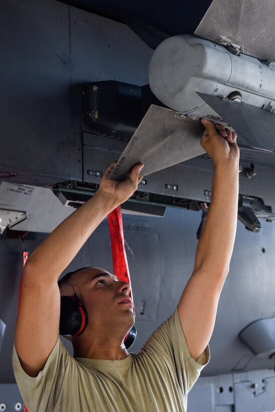 Airman 1st Class Dorian Estrella, 4th Aircraft Maintenance Squadron weapons load crew member, competes in a timed Load Crew of the Quarter competition, July 7, 2016, at Seymour Johnson Air Force Base, North Carolina. Crews from two different maintenance units competed against each other for the best time while ensuring accuracy, serviceability and efficiency. (U.S. Air Force photo/Airman Shawna L. Keyes)